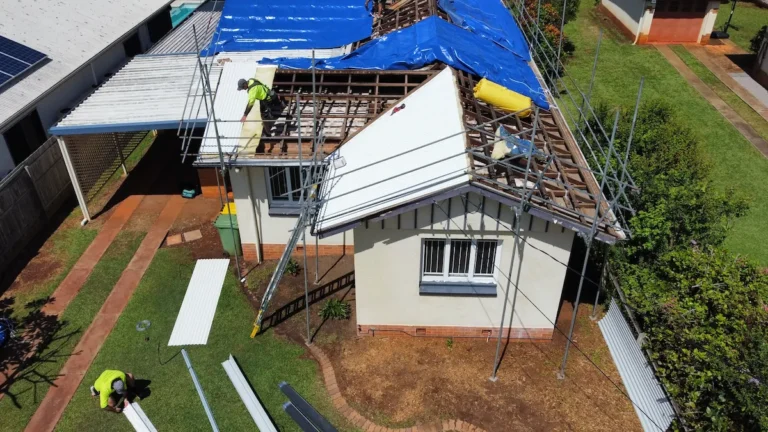 Reroofing being started after roof was tarped
